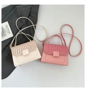 Top view of crocodile pattern luxury small square bags in beige and pink with strap