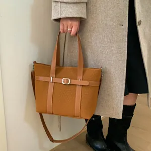 Retro brown jacquard bucket bag with belt detail worn with a beige autumn coat