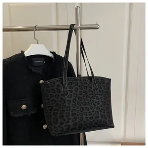 Detailed view of large leopard print tote bag fabric and sturdy dual shoulder straps