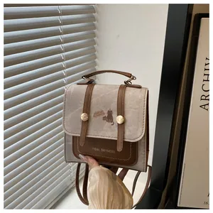 Detail of vintage canvas mini backpack with brown leather trim and cat motif