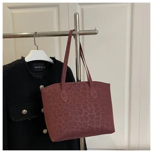 Detail view of the dark red leopard pattern texture on this large tote bag