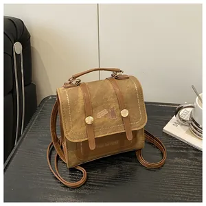 Detailed view of vintage canvas backpack with faux leather straps and cat print design