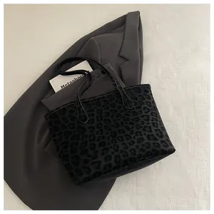 Detailed view of the leopard print suede texture on a chic large capacity tote bag