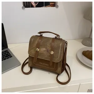 Detailed view of vintage canvas backpack with cat illustration on a minimalist desk