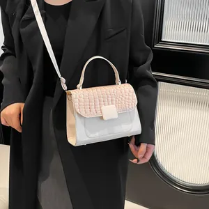 Women's crocodile embossed crossbody bag in beige and pink patchwork with top handle