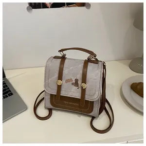 Detailed shot of retro small square backpack with marble texture and cute cat illustration