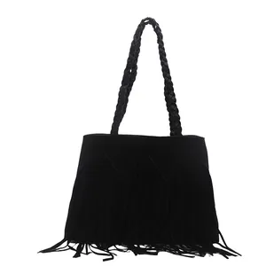 Chic black suede tote bag featuring fringe details and woven shoulder straps for women
