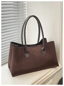 Detail of a vintage dark brown suede tote bag featuring high-quality matte leather texture