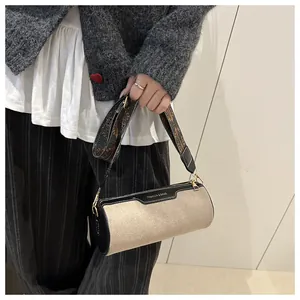 Detail of cylinder bag with canvas stitching and ethnic geometric pattern wide strap