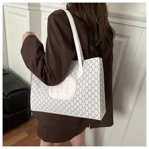 Close-up of Harajuku style white shoulder bag with embossed M logo and letter patterns