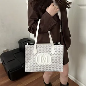 Japanese Harajuku style white tote bag with M-letter print shown by model in blazer