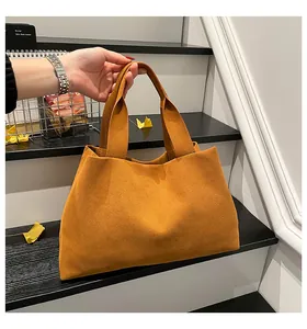 Detail of minimalist burnt orange felt tote bag with wide handle and thick texture