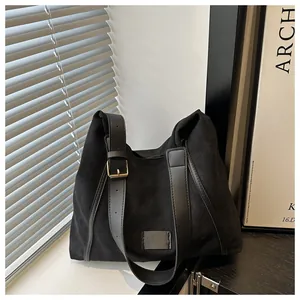 Detail of adjustable black leather strap with gold metal buckle on minimalist tote bag