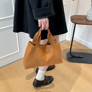 Minimalist caramel brown suede bucket tote bag with wide handle for women's winter fashion
