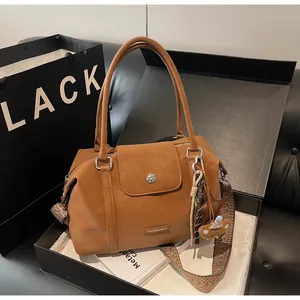 Brown Boston bag with patterned wide strap in a premium gift box presentation