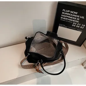 Macro detail of spacious black tote bag with striped lining and patterned strap