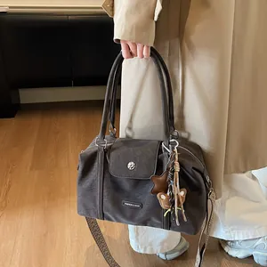Dark grey vintage leather pillow bag with wide patterned strap and star charms