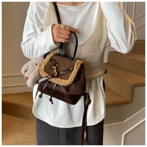 Detail of vintage dark brown bucket bag with plush trim and cute bunny charm accessory