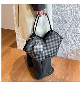 Detail of checkered bucket tote bag with V-shaped opening and matching mini coin purse