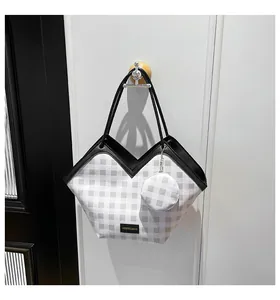 Detail of checkered bucket bag with contrast trim and matching round coin purse