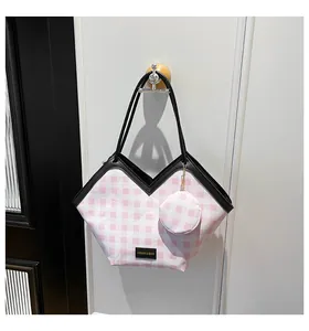 Detail of pink plaid bucket bag with V-cut top and matching round coin purse charm