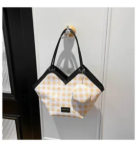 Detail of yellow and white checkered bucket bag with a matching mini round coin purse
