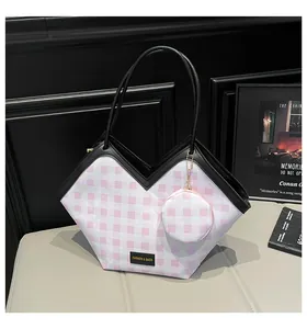 Detail view of pink plaid tote bag with V-shaped opening and mini coin purse attachment