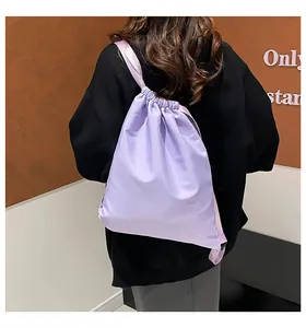 Rückansicht eines Models mit hellviolettem Kordelzug-Rucksack aus Nylon im Minimal-Stil