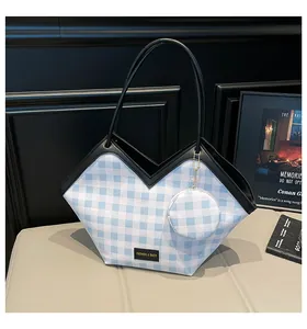 Blue and white checkered bucket bag with black handle and small round pouch