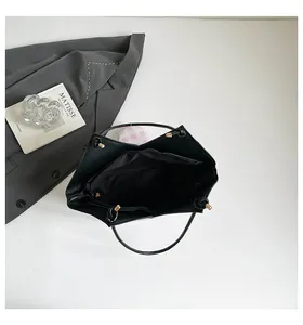 Top view of spacious black tote bag interior with fabric lining and slim handles