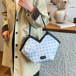 Blue gingham checkered tote bag with black trim and a matching mini round coin purse