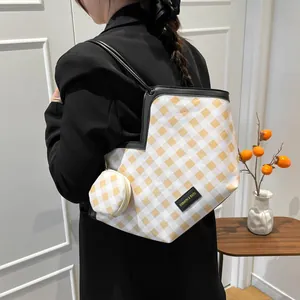 Yellow and white checkered tote bag with matching round coin purse on black suit model