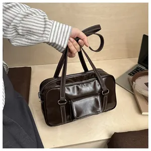 Detail of vintage dark brown faux leather handbag with white contrast stitching and dual handles