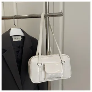 White faux leather rectangular bag with front pocket detail and slender shoulder straps