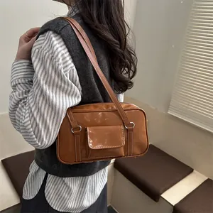 Minimalist brown glossy leather shoulder bag with vintage buckle and front pocket