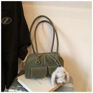Detailed view of an olive green vintage leather satchel with dual front flap pockets