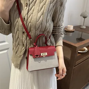 Chic red and white patchwork crossbody bag for women with gold hardware and top handle