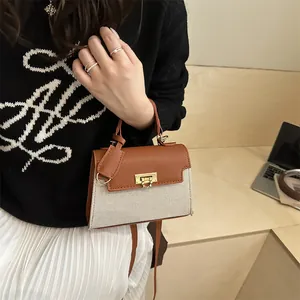 Elegant contrast patchwork handbag with gold clasp and brown leather handles in mini size
