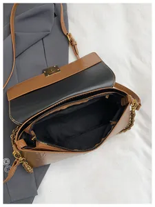 Detail of a brown vintage leather bag showing black fabric lining and a secure inner zipper
