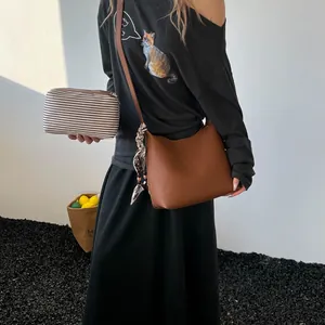 Brown lychee leather square shoulder bag with polka dot scarf and striped canvas pouch