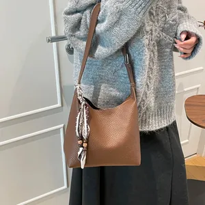 Brown litchi grain leather hobo bag with floral silk scarf and beaded charm accessory