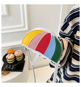 Detail of umbrella-shaped crossbody bag featuring a five-color patchwork design and strap