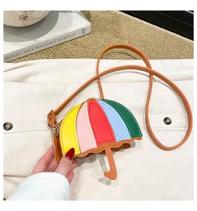 Detailed view of colorful umbrella-shaped mini crossbody bag with leather strap and charm
