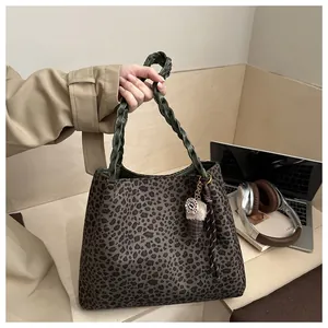 Leopard print tote bag with green braided handles and a cute ice cream charm detail