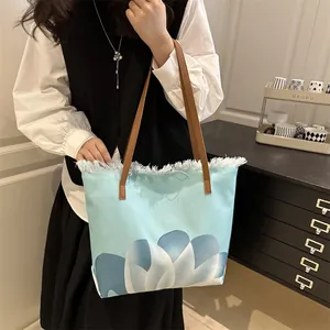 Bolso tote de lona azul claro con bordes deshilachados y correas de cuero marrón