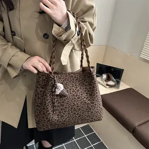 Leopard print tote bag with woven handles and ice cream charm on a female model