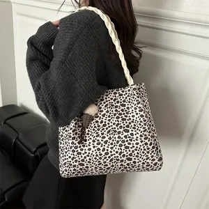 Leopard print tote bag with braided cream strap and plush ice cream charm shown on shoulder