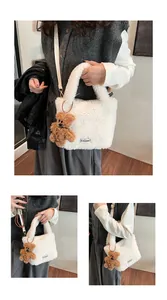 Detail of white plush bucket bag with a cute brown bear charm and adjustable strap