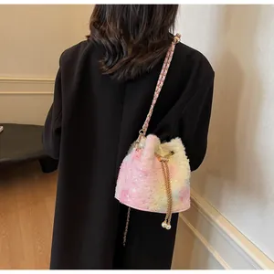 Detail of plush bucket bag featuring rainbow gradient fur, sequins, and pearl drawstring