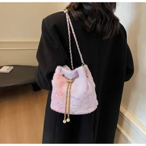 Detail of plush bucket bag with pink gradient faux fur, star pattern and pearl charms